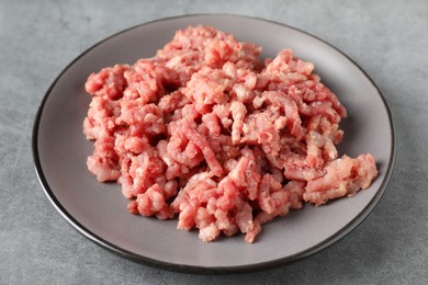 Raw ground meat on grey table, closeup