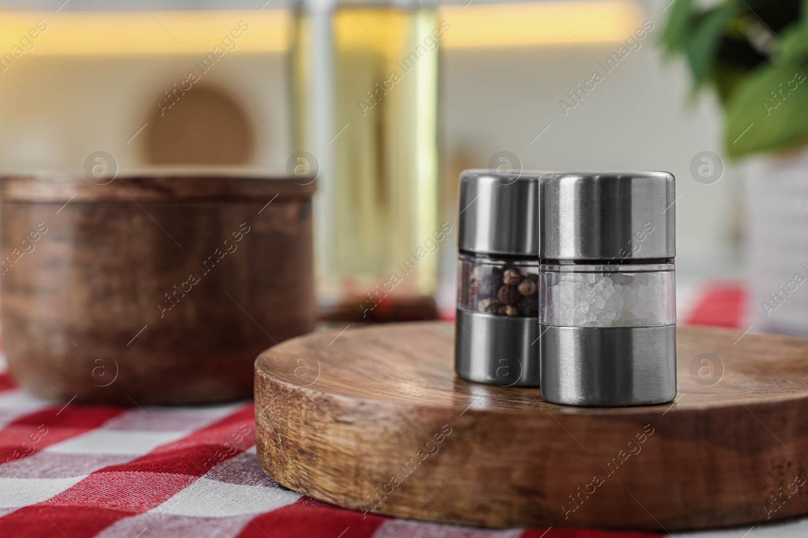 Photo of Metal salt and pepper shakers on table, space for text