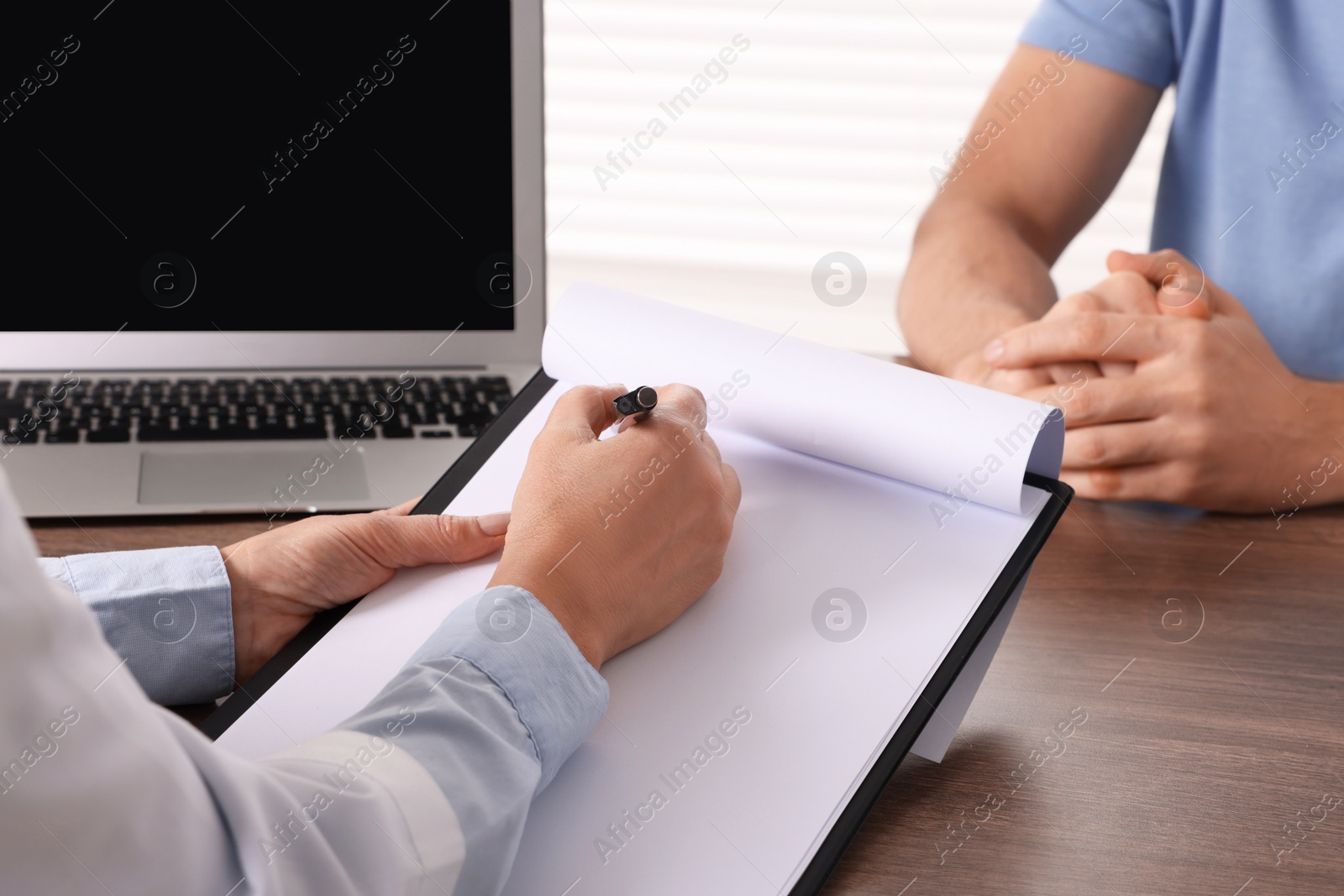 Photo of Doctor with clipboard in clinic, closeup. Patient consultation