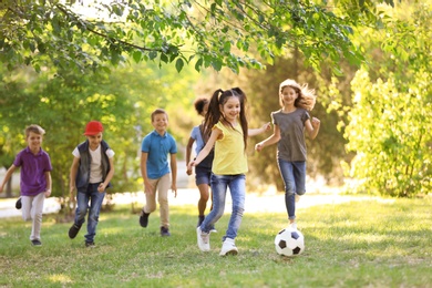 Photo of Cute little children playing with ball outdoors on sunny day