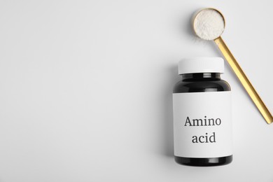 Amino acid powder and jar on white background, top view