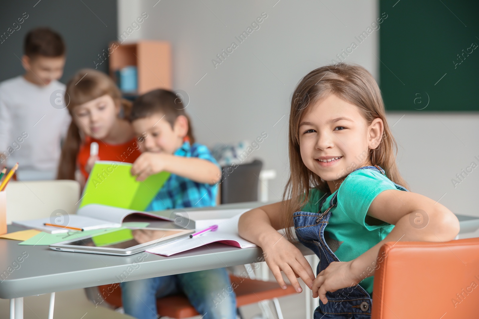 Photo of Cute little girl in classroom at school