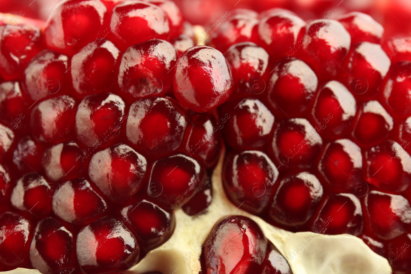 Photo of Ripe juicy pomegranate grains as background, closeup