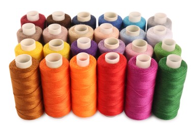 Photo of Set of colorful sewing threads on white background