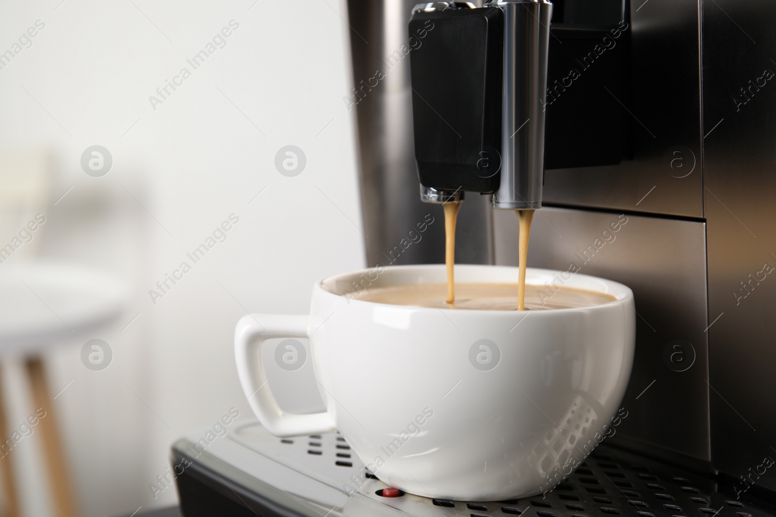 Photo of Espresso machine pouring coffee into cup against blurred background, closeup. Space for text