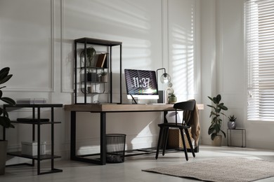 Photo of Room interior with comfortable workplace. Modern computer on wooden desk