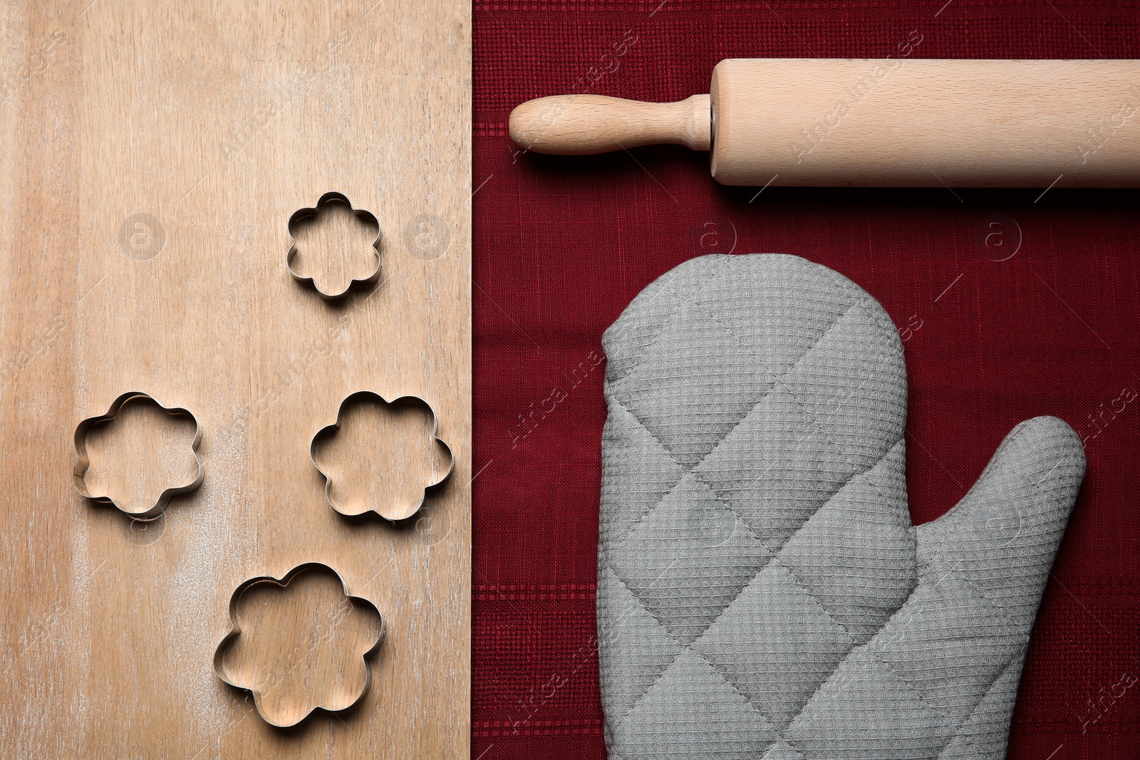 Photo of Flat lay composition with oven glove and kitchenware on wooden table