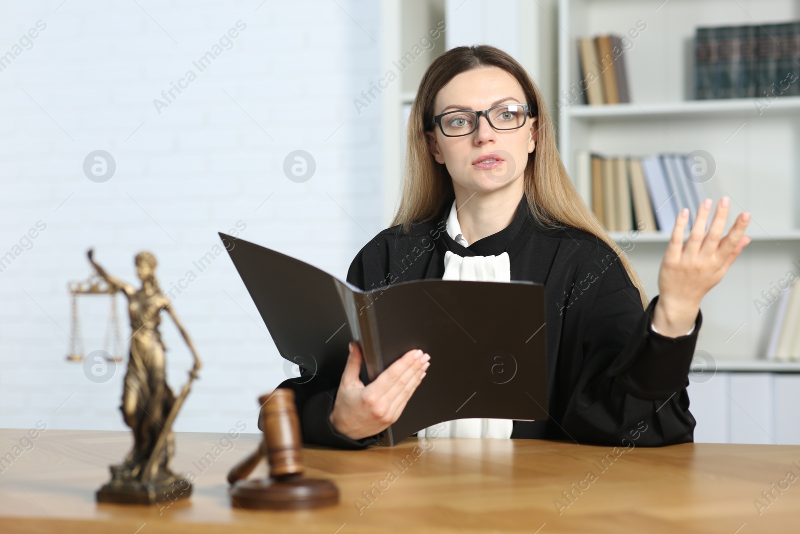 Photo of Judge with folder working indoors, selective focus