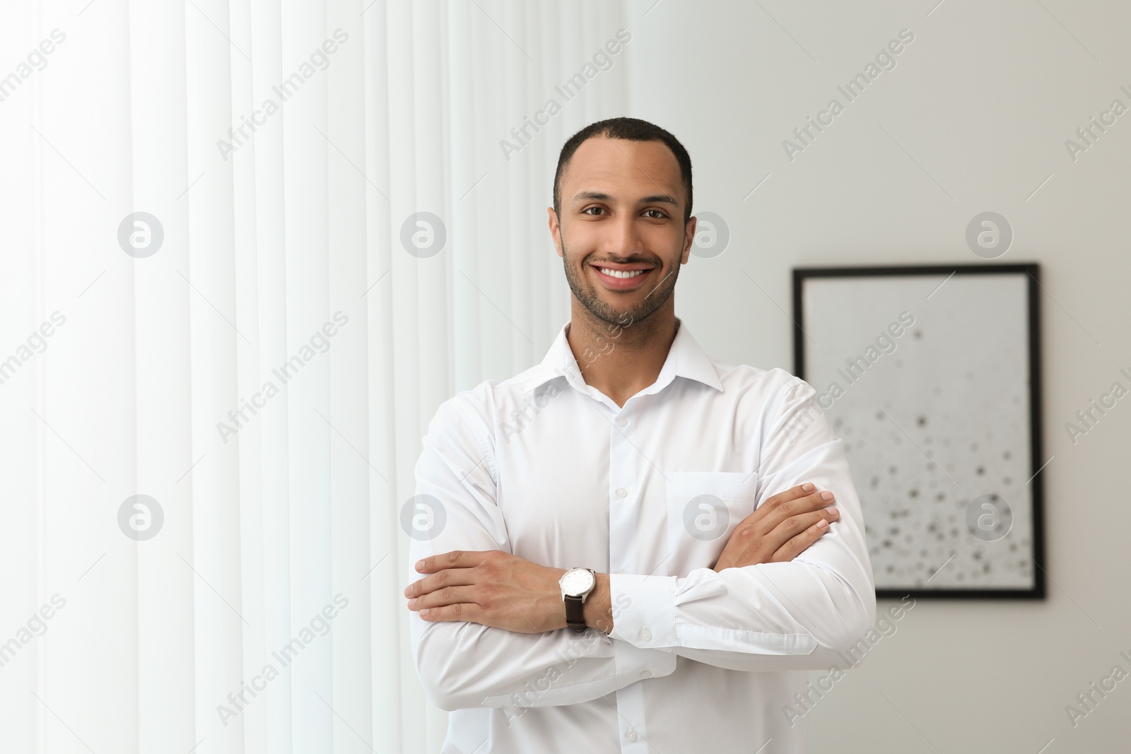 Photo of Portrait of handsome young man in white shirt indoors