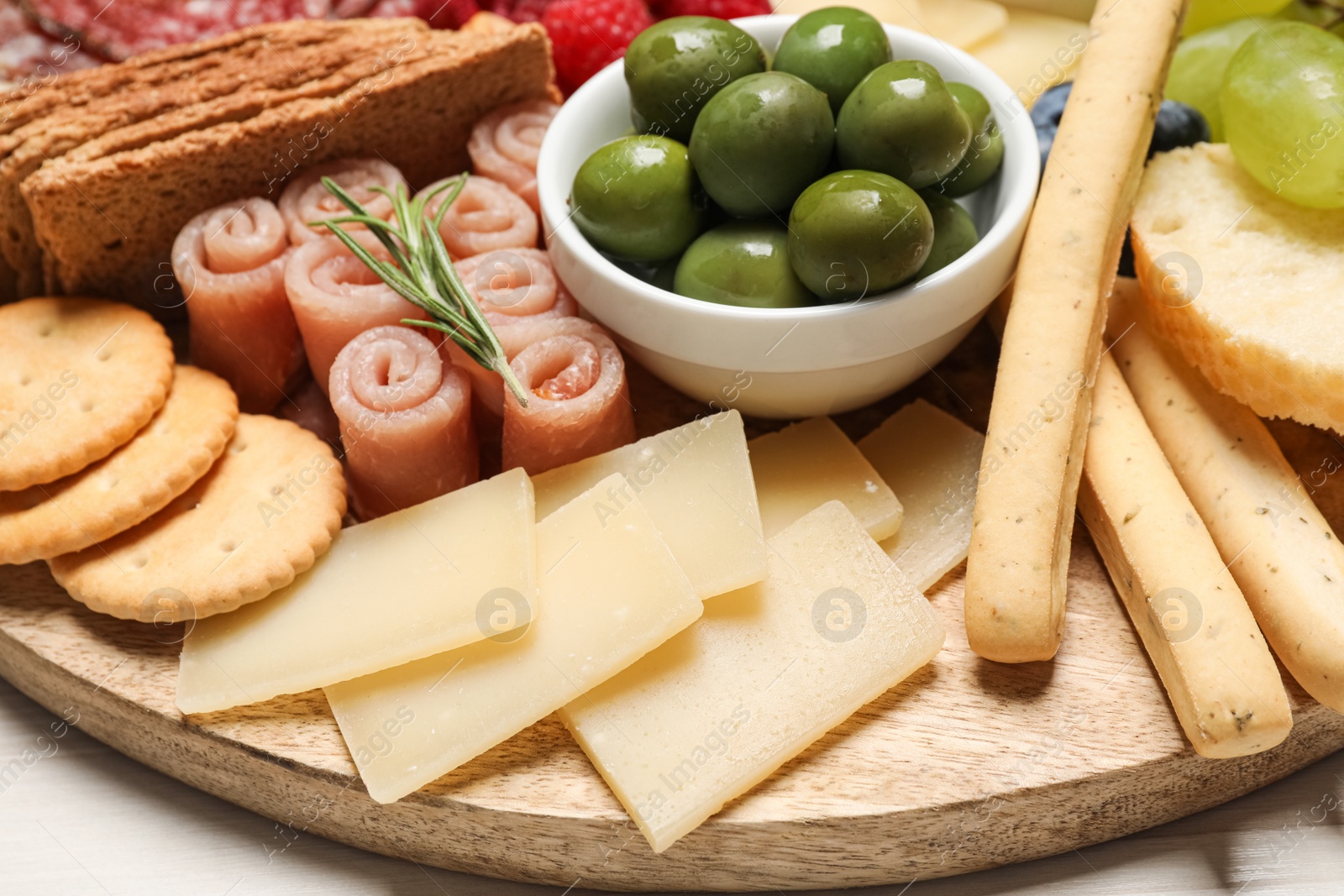 Photo of Tasty parmesan cheese and other different appetizers, closeup