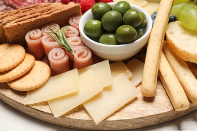 Photo of Tasty parmesan cheese and other different appetizers, closeup