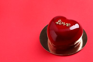 St. Valentine's Day. Delicious heart shaped cake on red background, closeup. Space for text