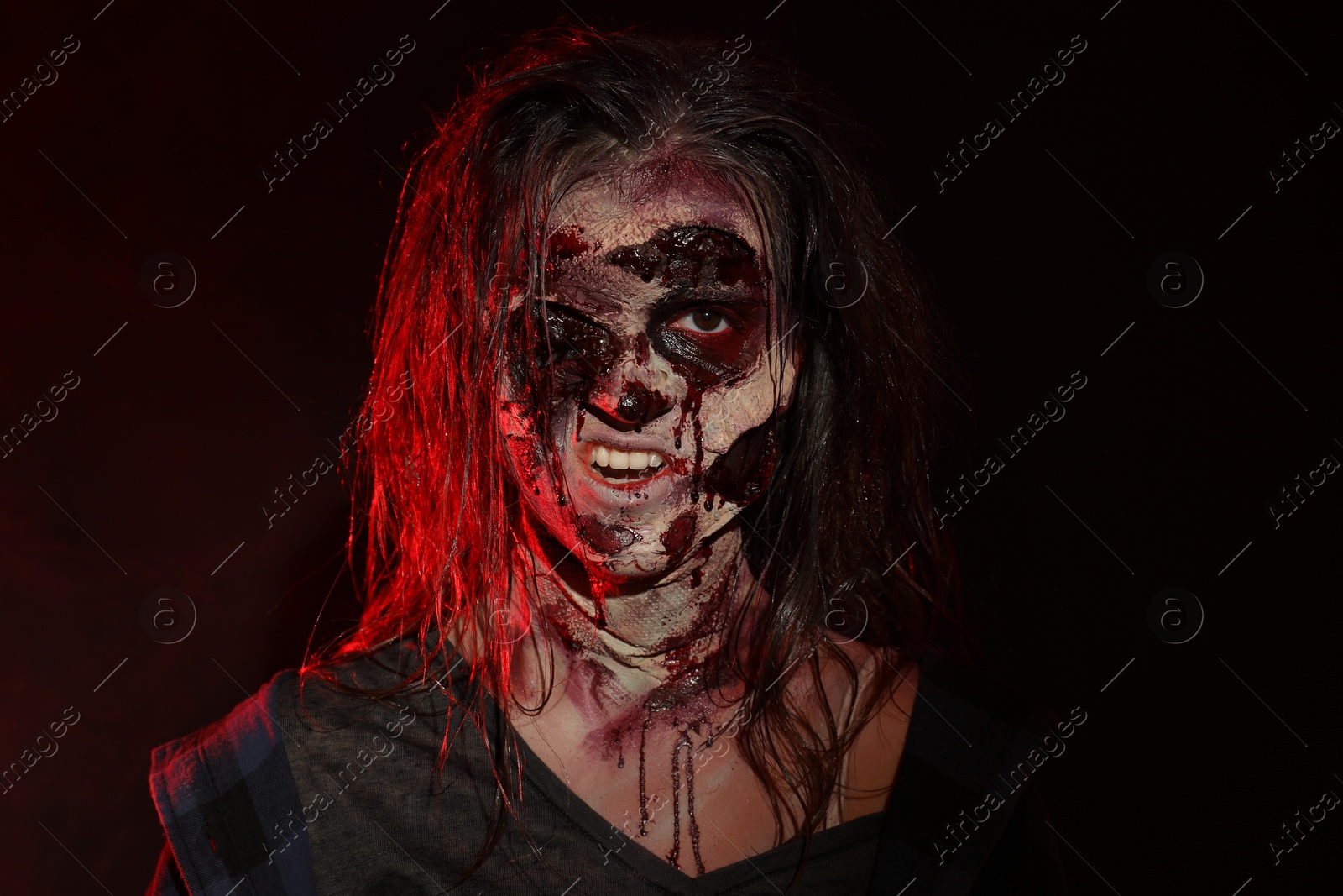 Photo of Scary zombie on dark background. Halloween monster