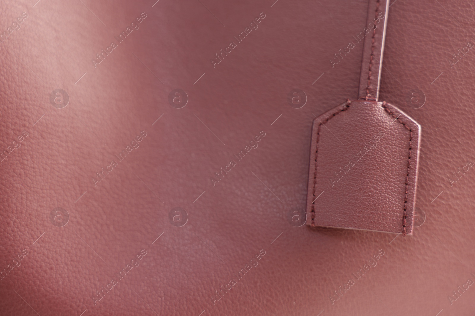 Photo of Texture of leather and tag as background, closeup view