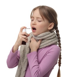 Photo of Little girl with scarf using throat spray on white background