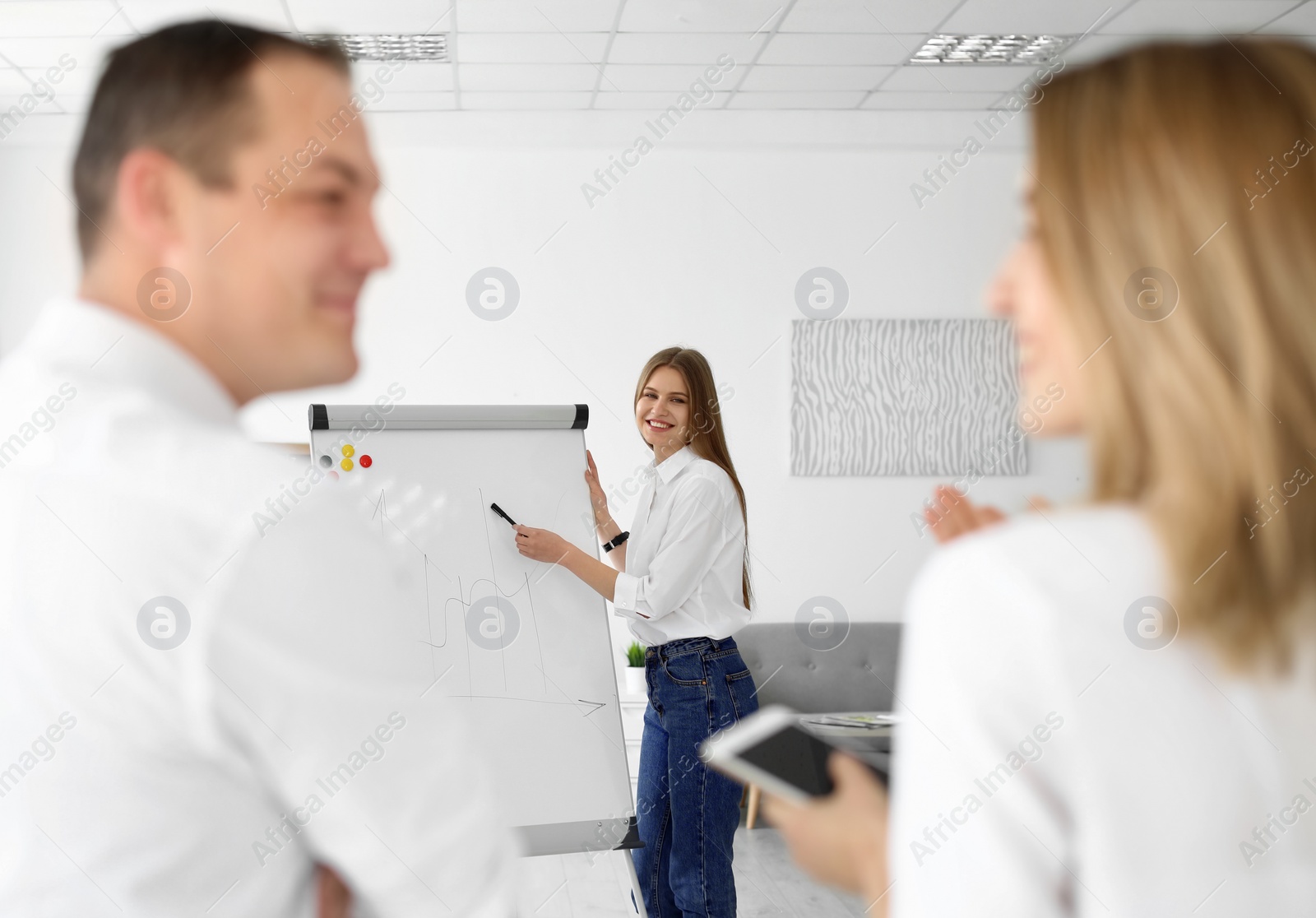 Photo of Female business trainer giving lecture in office