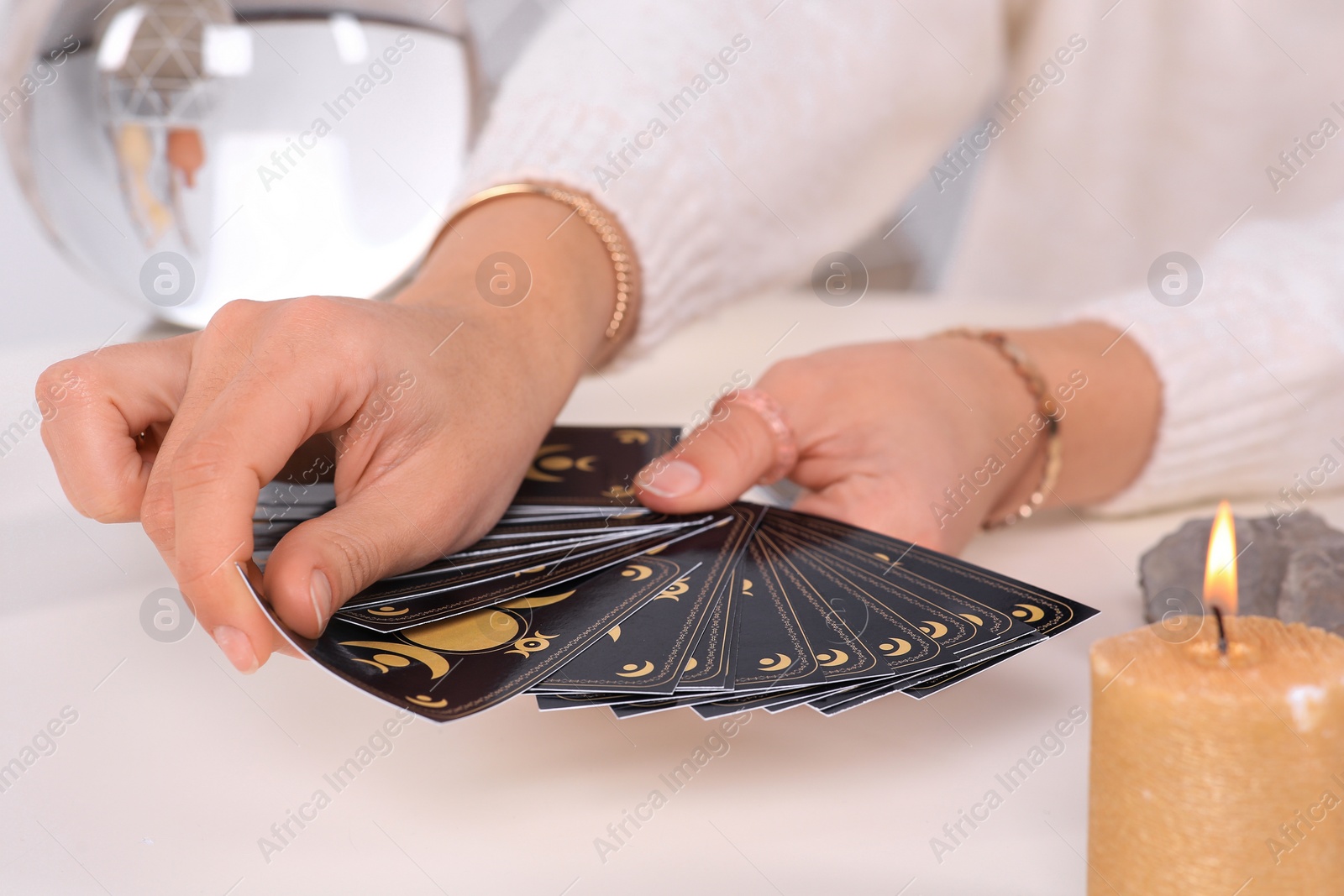 Photo of Soothsayer pulling one tarot card at table, closeup. Future telling