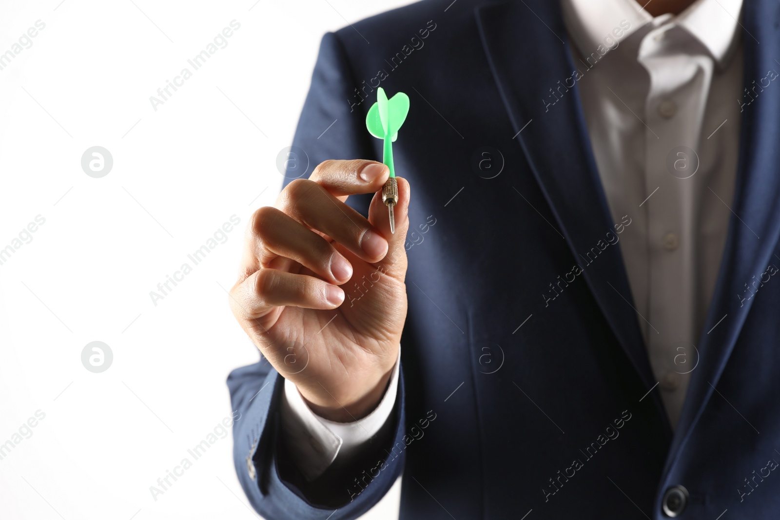 Photo of Man holding green dart on light background, closeup