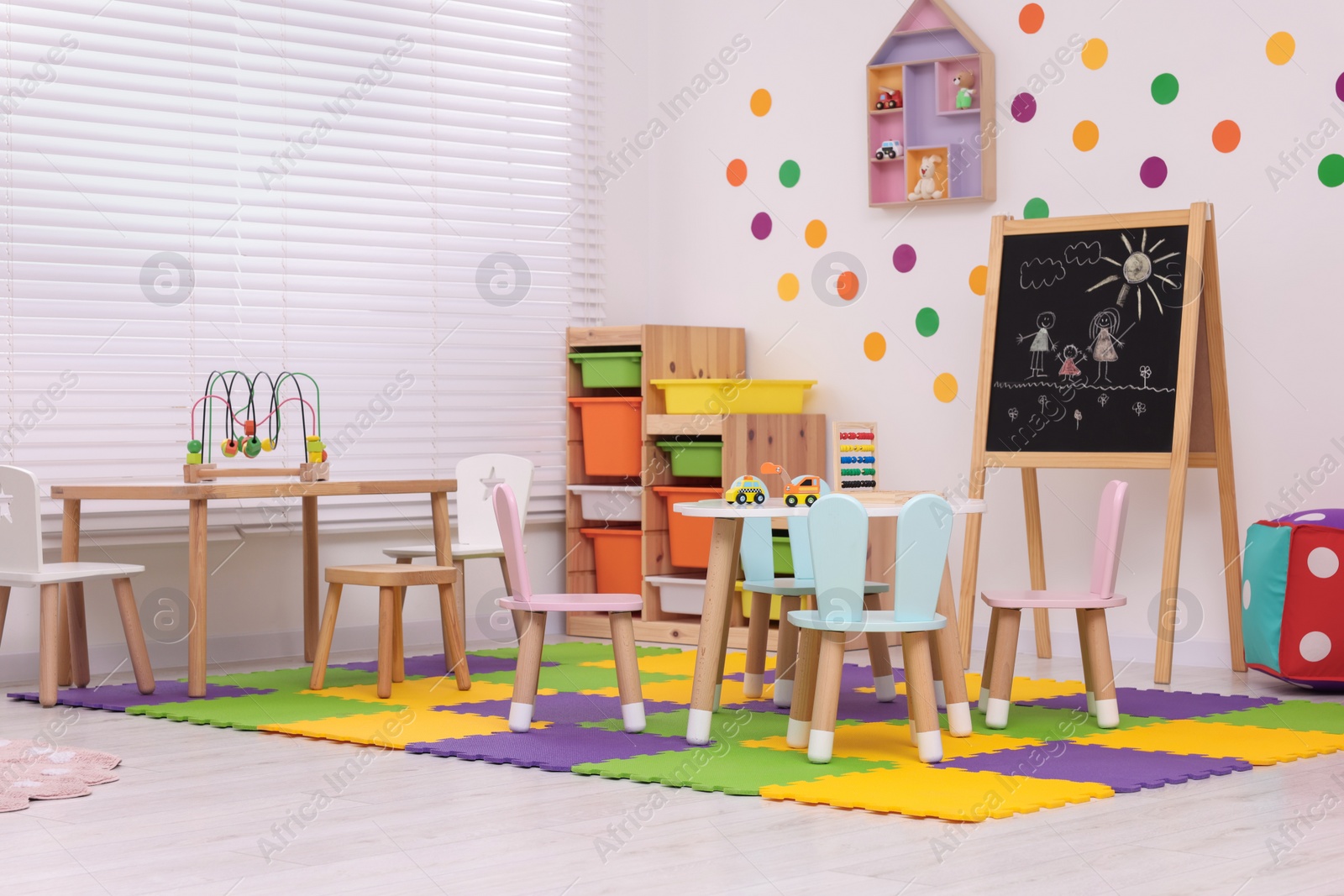 Photo of Stylish kindergarten interior with toys and modern furniture