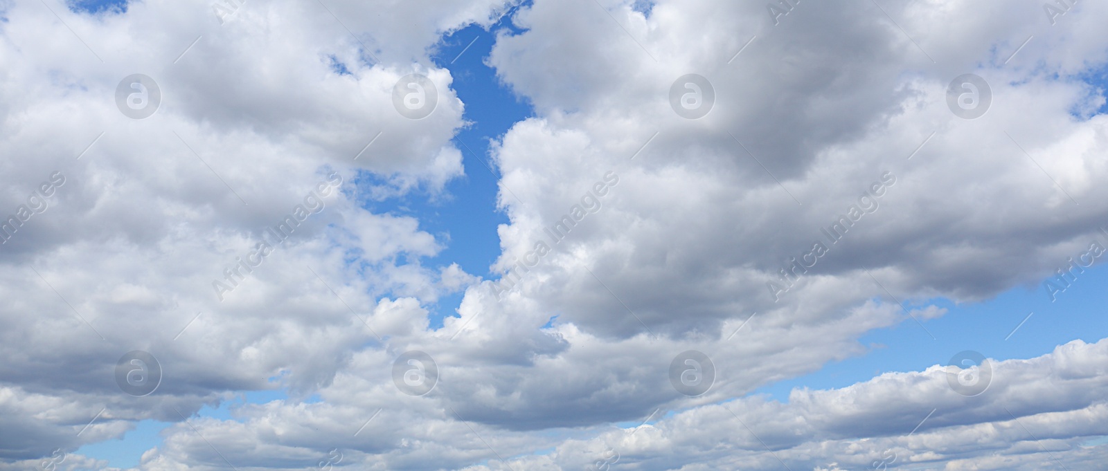 Image of Picturesque view of beautiful blue sky with fluffy clouds, banner design