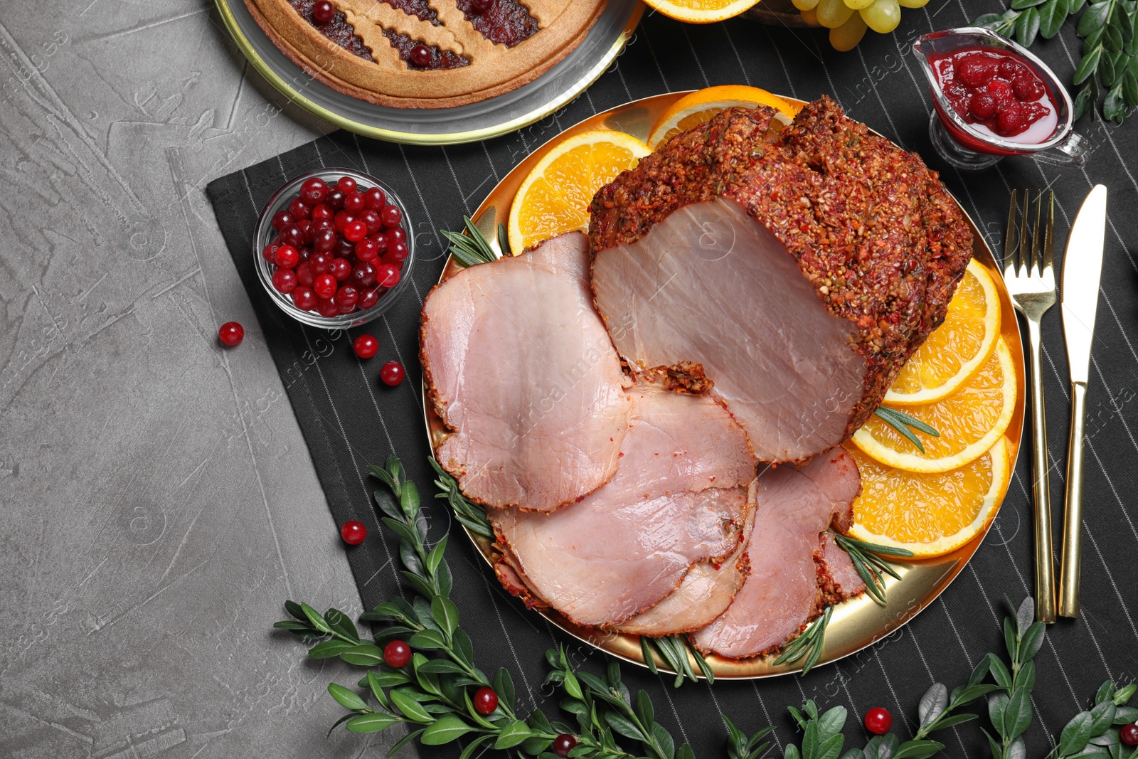 Photo of Flat lay composition with delicious ham for Christmas dinner on grey table