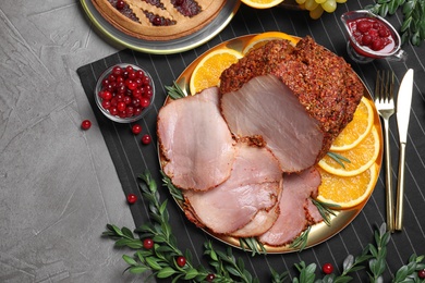 Flat lay composition with delicious ham for Christmas dinner on grey table