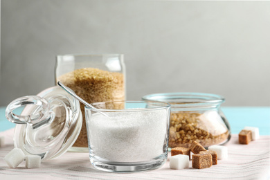 Various bowls with different sorts of sugar on table