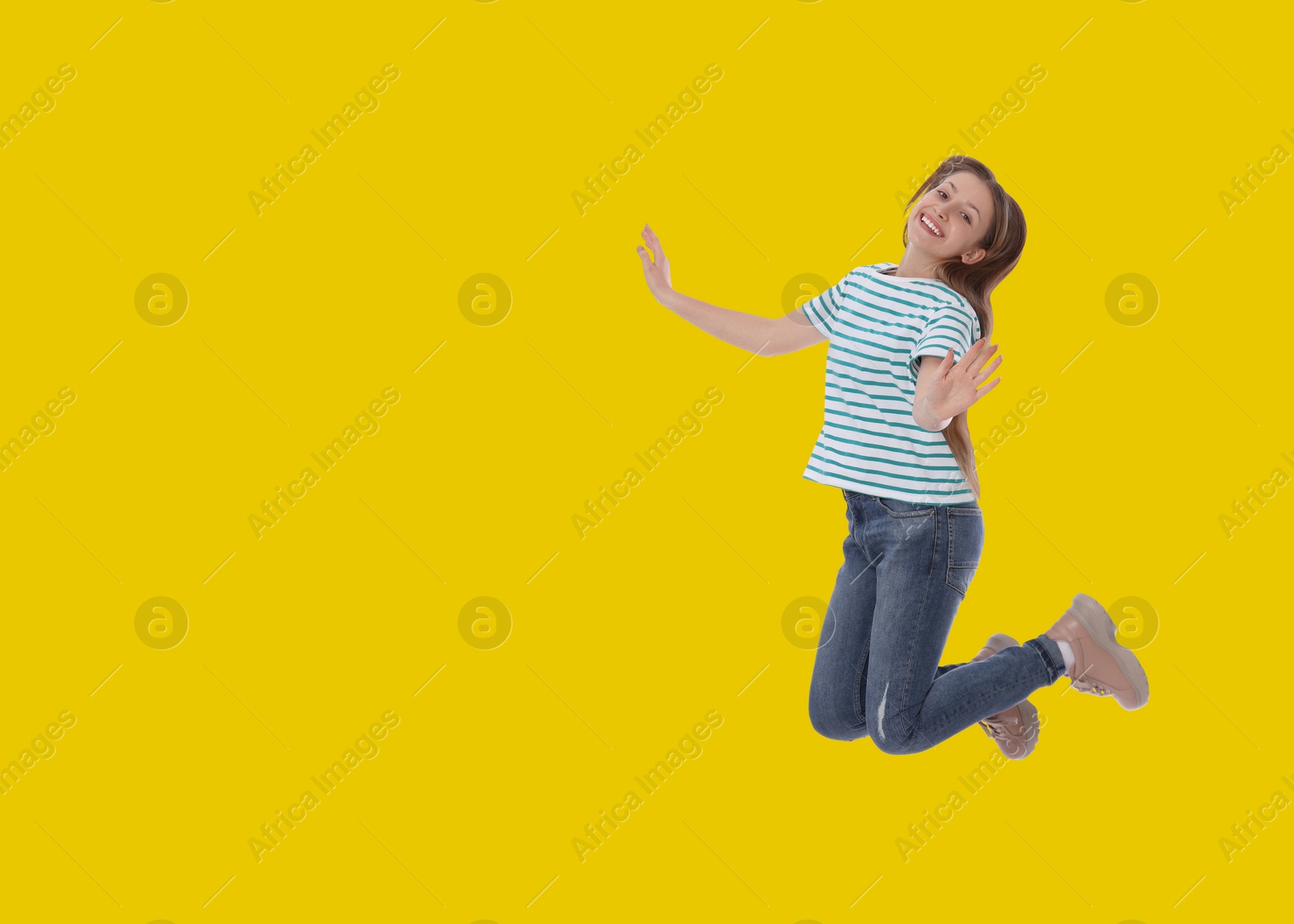 Image of Cute girl jumping on golden background, space for text