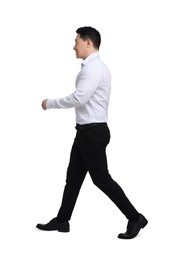 Photo of Businessman in formal clothes walking on white background