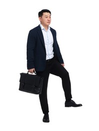 Businessman in suit with briefcase walking on white background