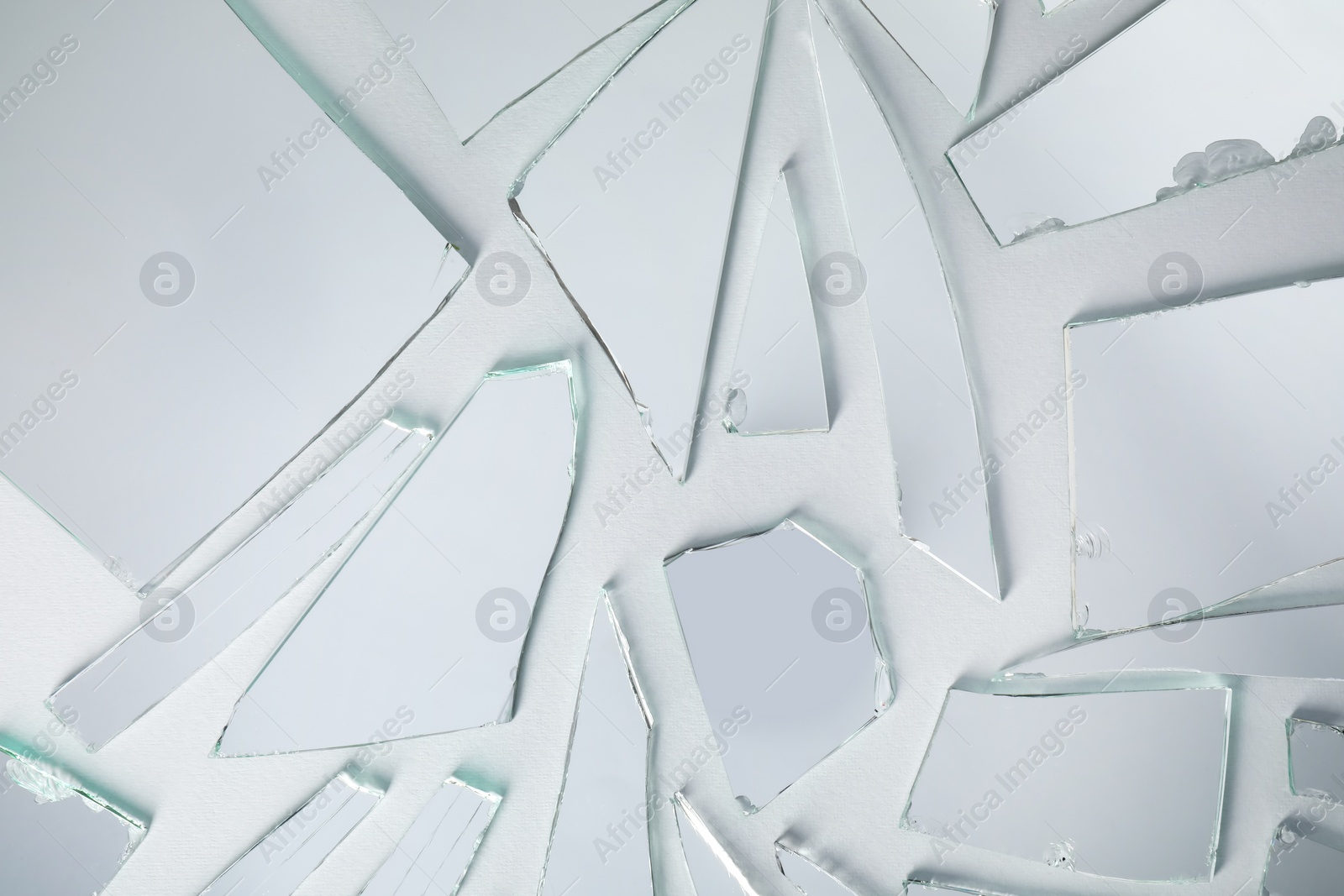 Photo of Shards of broken mirror on white background, top view