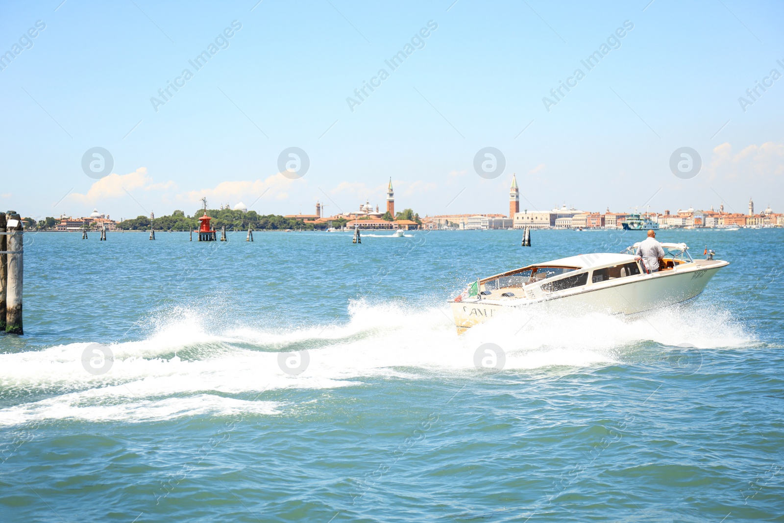 Photo of VENICE, ITALY - JUNE 13, 2019: Picturesque seascape with launch boat