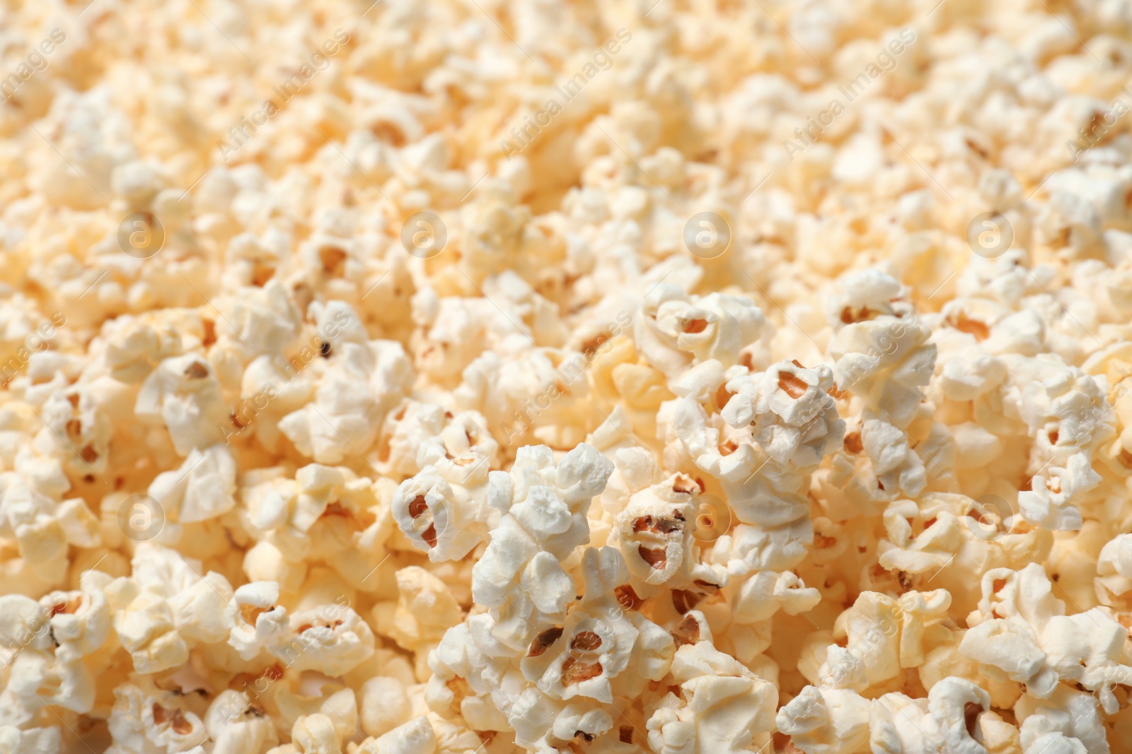 Photo of Fresh popcorn as background, closeup. Tasty snack