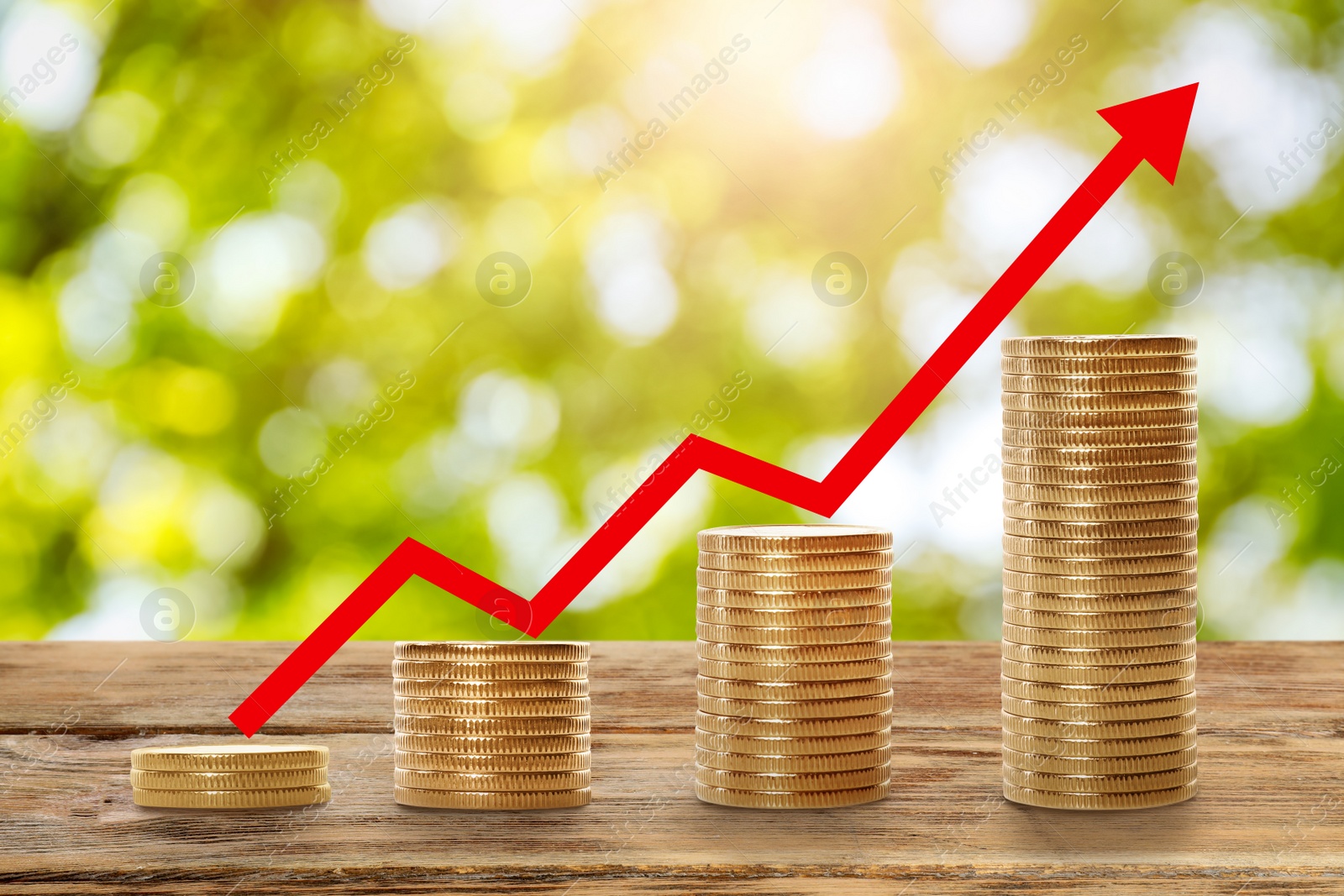 Image of Stacked coins on wooden table against blurred background. Investment concept