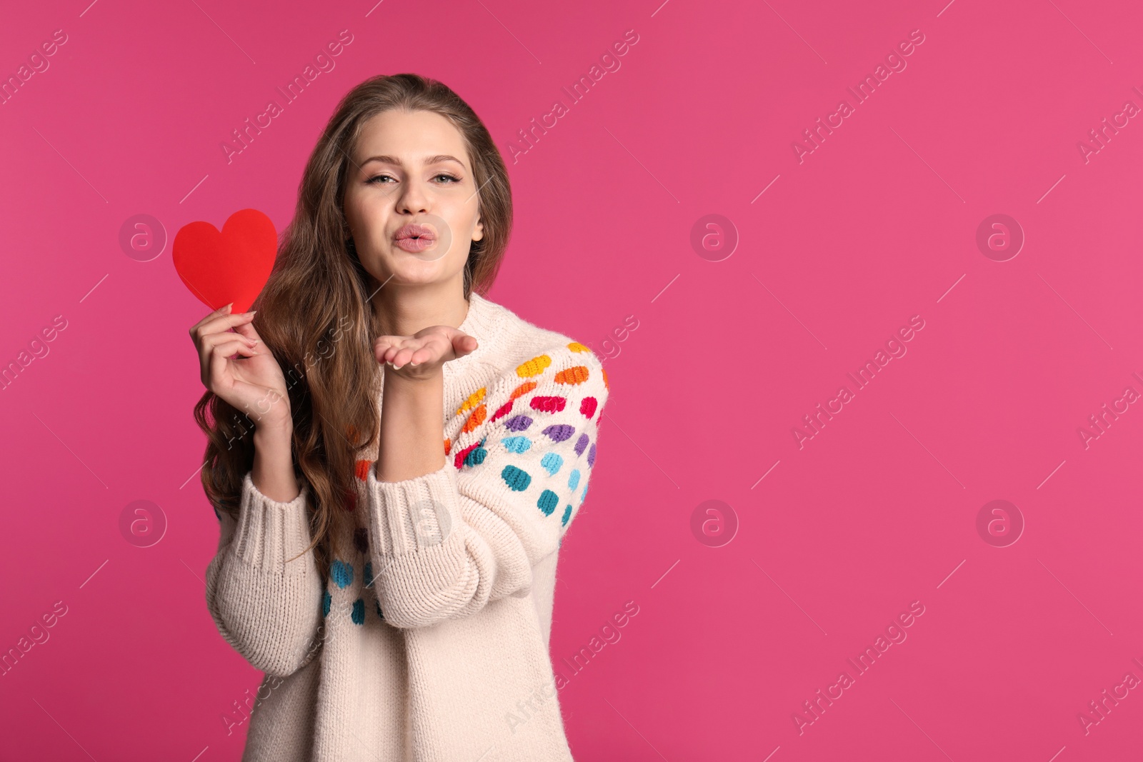 Photo of Portrait of young woman with decorative heart on color background. Space for text