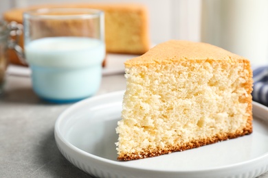 Piece of delicious fresh homemade cake on light grey marble table