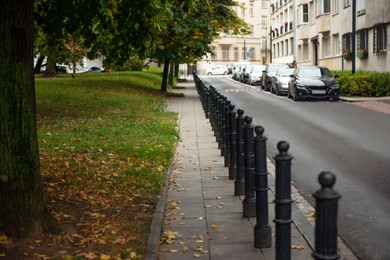 Beautiful view of sidewalk path near road with cars outdoors. Footpath covering