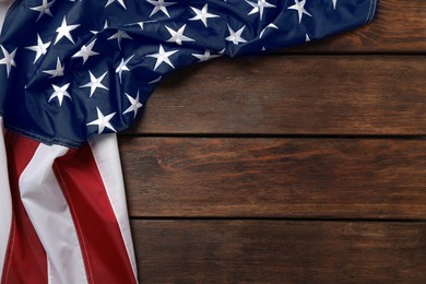 Photo of American flag on wooden table, top view with space for text. Memorial Day
