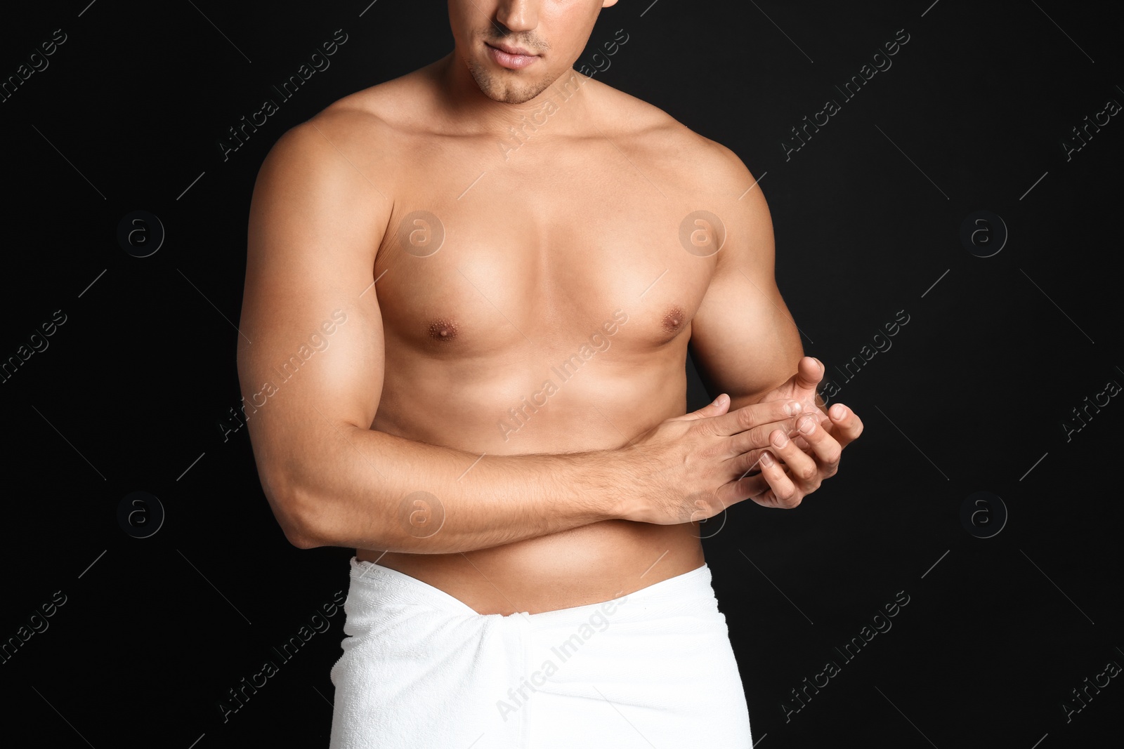 Photo of Man with sexy body on black background, closeup