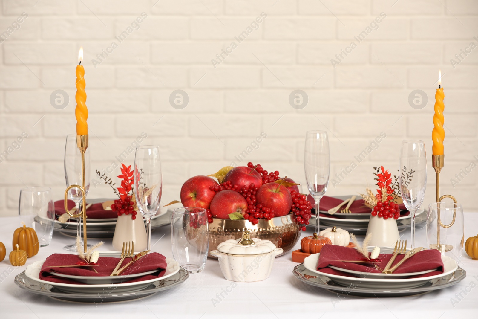 Photo of Elegant festive setting with autumn decor on table