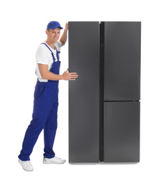 Professional worker carrying refrigerator on white background