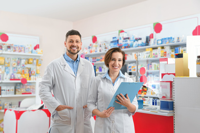 Image of Portrait of professional pharmacists in modern drugstore