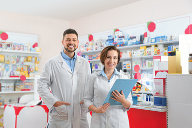 Portrait of professional pharmacists in modern drugstore