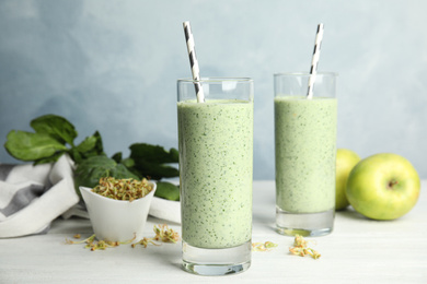 Photo of Green buckwheat smoothie on white wooden table