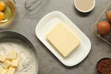 Photo of Flat lay composition with fresh butter and other products on grey textured table