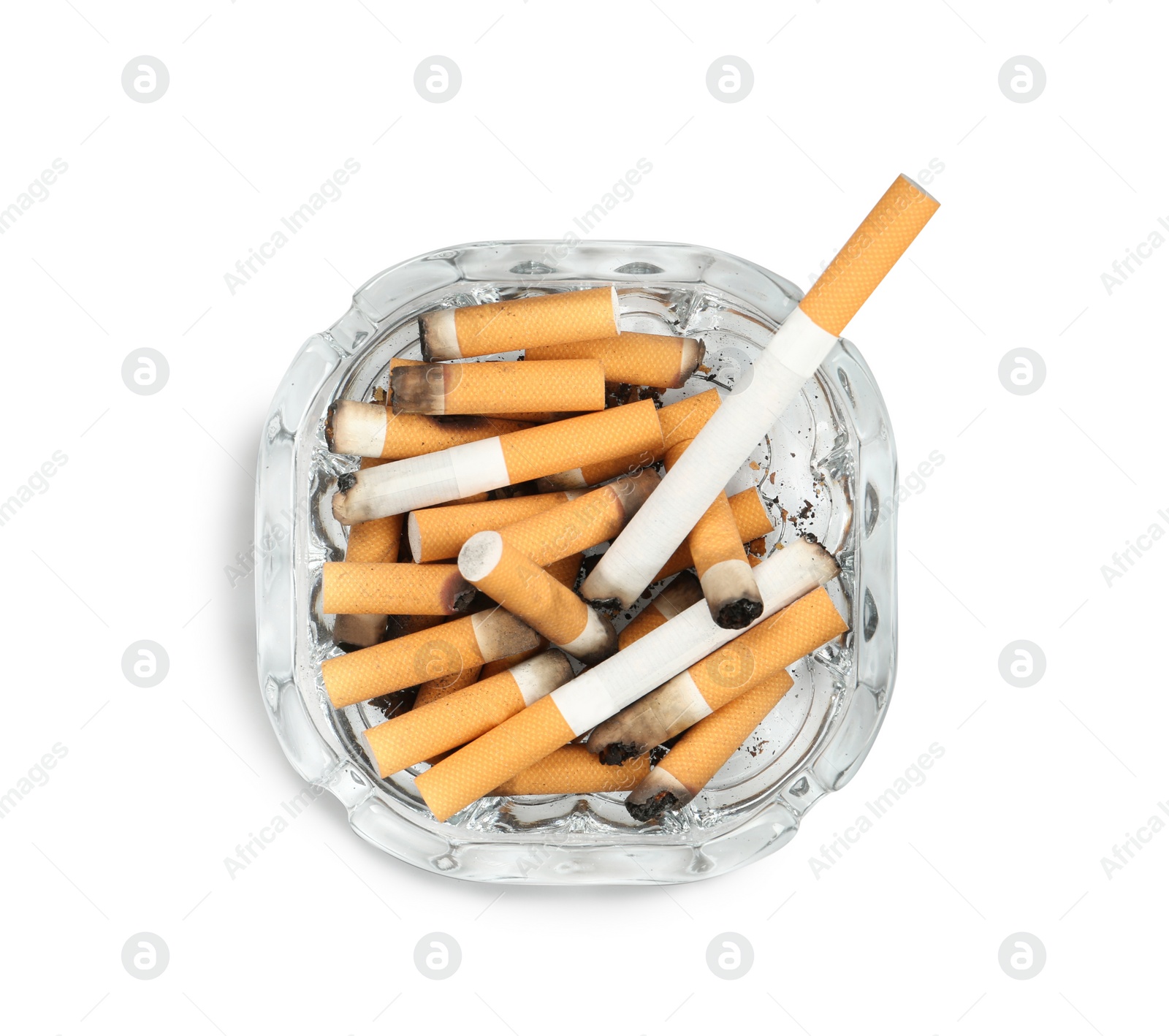 Photo of Glass ashtray full of cigarette stubs isolated on white, top view