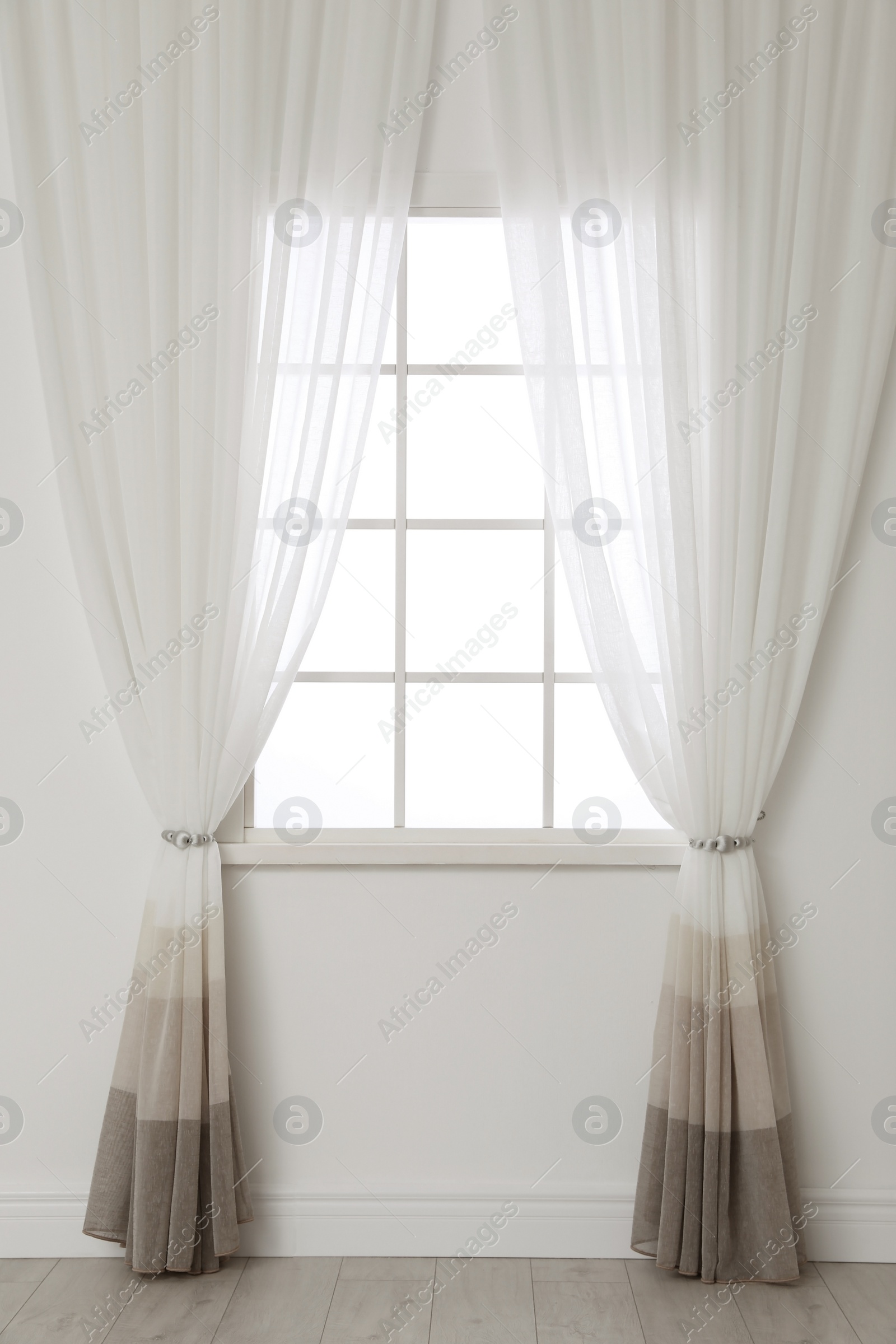 Photo of White wall with modern window and curtains indoors. Living room interior