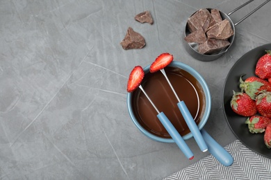 Photo of Flat lay composition with chocolate fondue and space for text on grey stone background