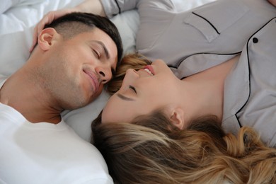 Photo of Lovely couple enjoying time together on bed