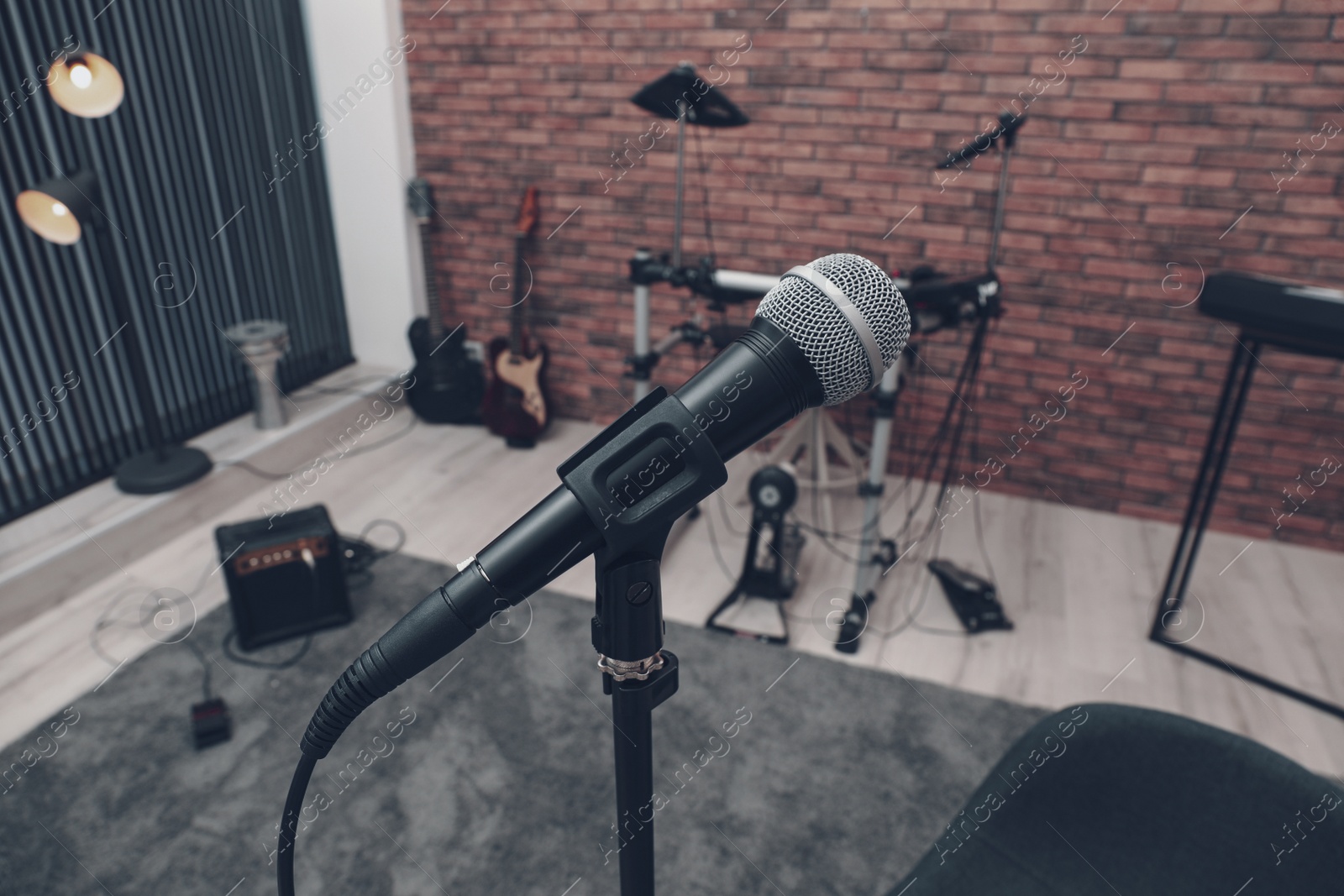 Photo of Musical instruments in studio, focus on microphone